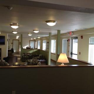 A well-lit interior space with seating areas and large windows.