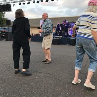 Seniors enjoying a lively outdoor dance event.
