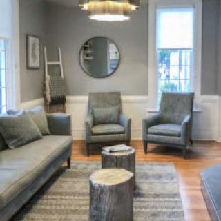 A modern living room with stylish furniture and neutral tones.