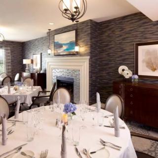 An elegant dining room with a formal table setting and stylish decor.