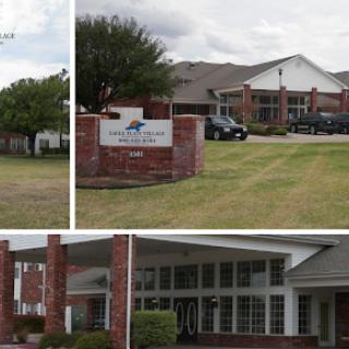 A view of a building with signage, showcasing both exterior and landscaping.
