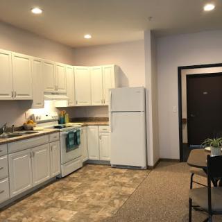 A well-lit kitchen featuring modern appliances and a dining area.