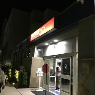 A brightly lit restaurant entrance at night.