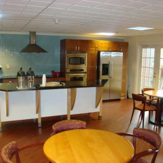 A modern kitchen and dining area featuring stainless steel appliances and stylish furniture.