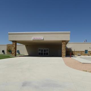 A view of a community center building under a clear blue sky.