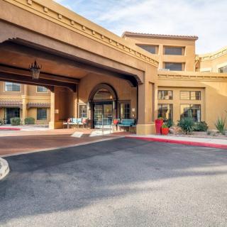 The entrance to a welcoming hotel with a covered driveway and distinctive architecture.