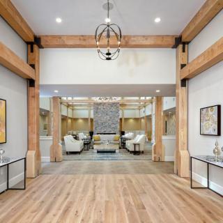 A modern living room with wooden beam accents and contemporary furnishings.