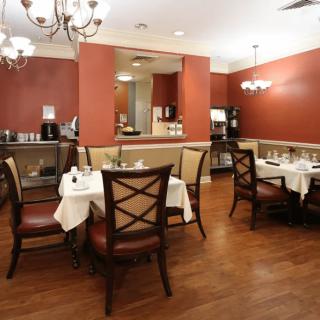 An elegant restaurant dining area with neatly arranged tables and chairs.