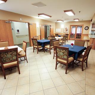 A well-lit dining area featuring tables and chairs arranged neatly.