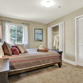 Cozy bedroom with bed, closet, and elegant decor.