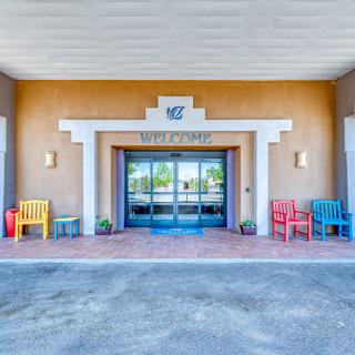 Entrance of a building with colorful chairs and architectural elements.