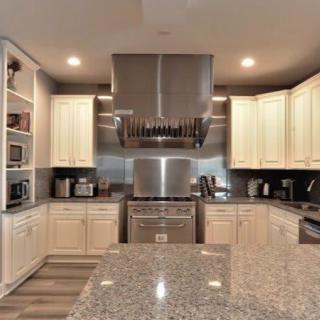 A modern kitchen with granite countertops, stainless steel appliances, and ample cabinet space.