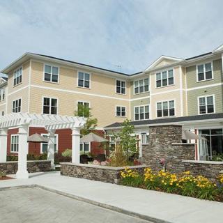 A modern apartment building with landscaped surroundings and a welcoming entrance.