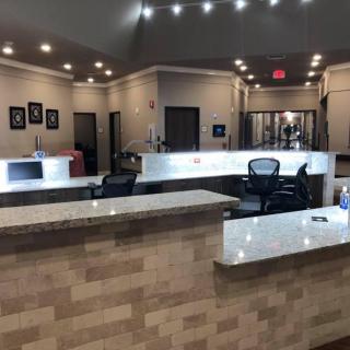 A modern office reception area with a sleek desk and comfortable seating.