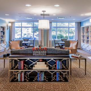 A cozy library interior with bookshelves and comfortable seating.