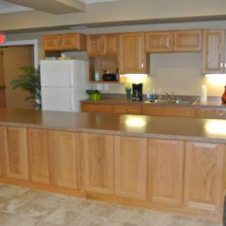 A modern kitchen with wooden cabinets and a spacious countertop.