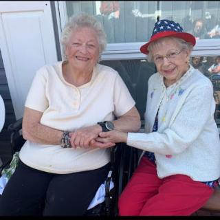 Two joyful friends sharing a moment together on a sunny day.