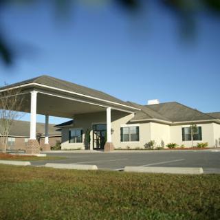 A welcoming entrance to a well-designed building under a clear blue sky.