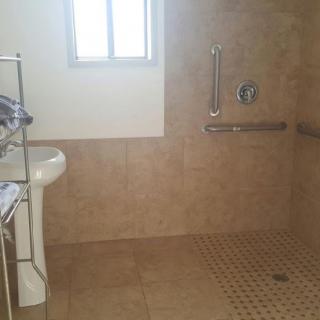 An accessible bathroom with a walk-in shower and grab bars.