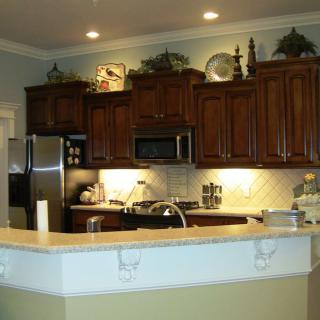 A modern kitchen with wooden cabinets and stainless steel appliances.