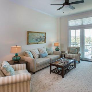A cozy and well-lit living room with comfortable seating and tasteful decor.