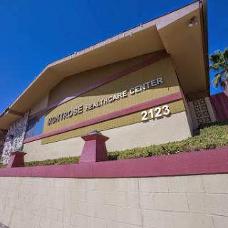 Exterior view of a medical center with signage displaying the address and name.