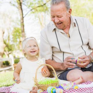 A grandparent and child enjoying a picnic together in the park.