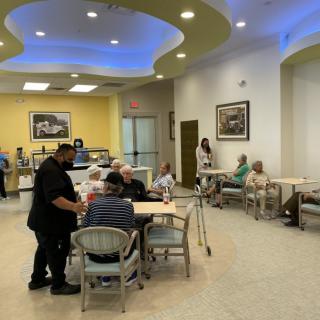 People enjoying their time at a cafe with comfortable seating and service.