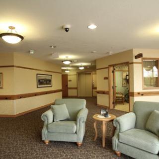 A cozy seating area in a well-lit lobby with comfortable sofas and a small table.