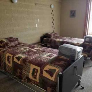 A retro-styled bedroom with twin beds and an old television set.