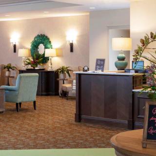 A warm and inviting lobby area featuring comfortable seating, tasteful decor, and ambient lighting.