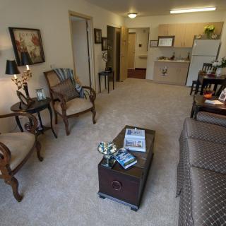 A cozy living room with classic furniture and decor in an apartment setting.