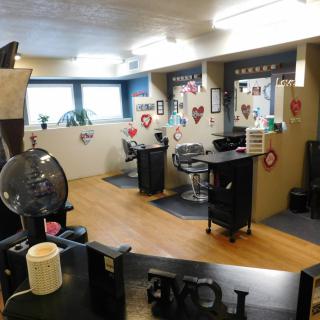 A cozy hair salon interior decorated with heart-themed decor.