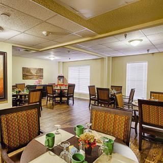 A cozy dining room with elegantly set tables and comfortable seating.