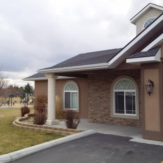 A suburban house with brick exterior and arched windows.