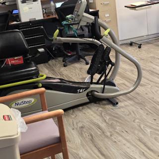 A modern exercise machine designed for rehabilitation and fitness within a healthcare setting.