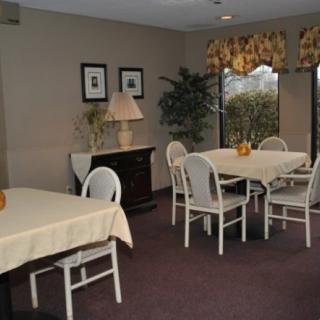 A cozy dining area with tables and chairs, complemented by indoor plants and decor.