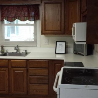 A cozy kitchen with wooden cabinets, a sink, and appliances.