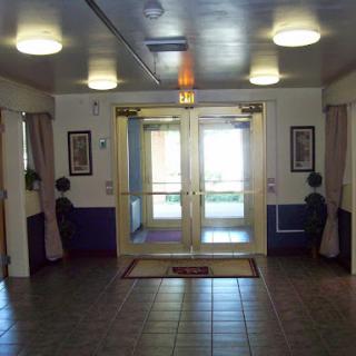 A view of the lobby entrance featuring double glass doors and tile flooring.
