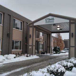 A winter view of a hotel entrance, adorned with snow.