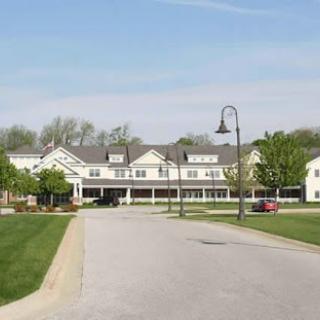 A peaceful residential community with well-maintained greenery and a charming building.