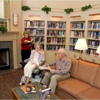 Seniors enjoying a cozy reading area in a library.