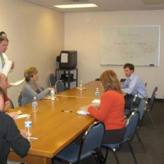 A group of people having a meeting in an office conference room.