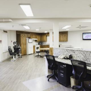 A modern office space featuring multiple workstations, sleek furniture, and a neutral color palette.