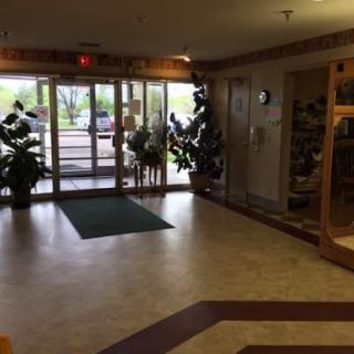 A welcoming lobby entrance featuring plants and a spacious floor area.