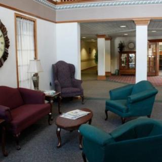 A comfortable lobby area with armchairs, a sofa, and a coffee table.