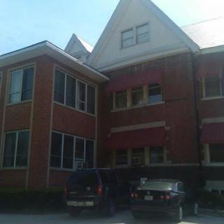 A brick building showcasing unique architectural features under a clear sky.