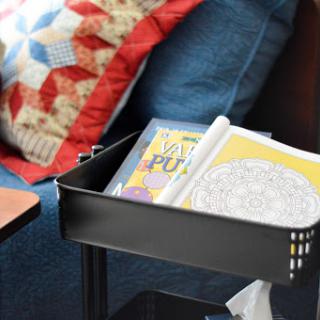 A cozy reading nook featuring a collection of books and a colorful quilt.