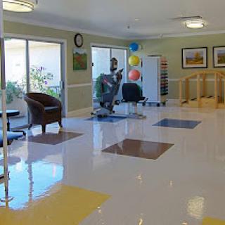 A bright and welcoming lobby area featuring comfortable seating and a clean, colorful floor.