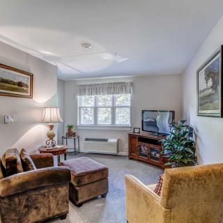 A cozy living room with plush seating, a television, and decorative elements.